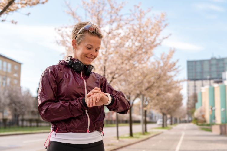 Woman checking her watch before a workout